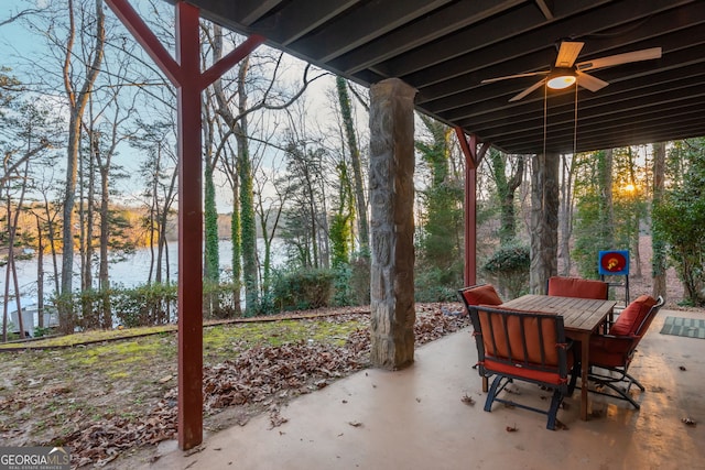 view of patio featuring a water view and ceiling fan