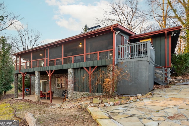 back of house featuring a patio and a sunroom