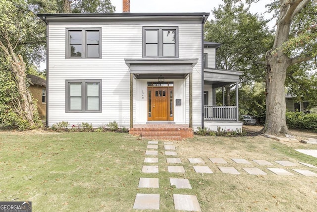 view of front of home featuring a front yard and a porch