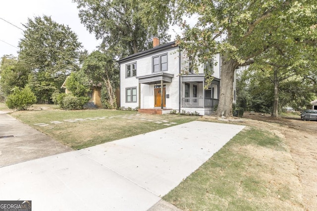 view of front of house with covered porch and a front lawn