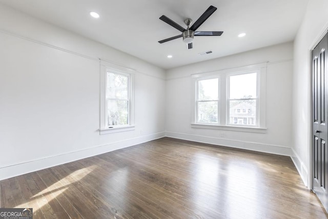 unfurnished room featuring dark wood-type flooring and ceiling fan