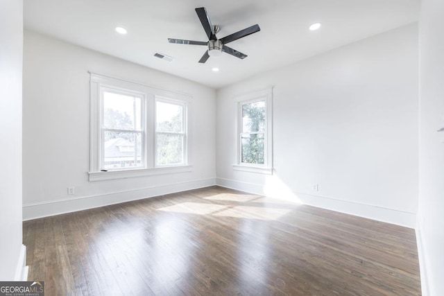 unfurnished room featuring dark wood-type flooring and ceiling fan