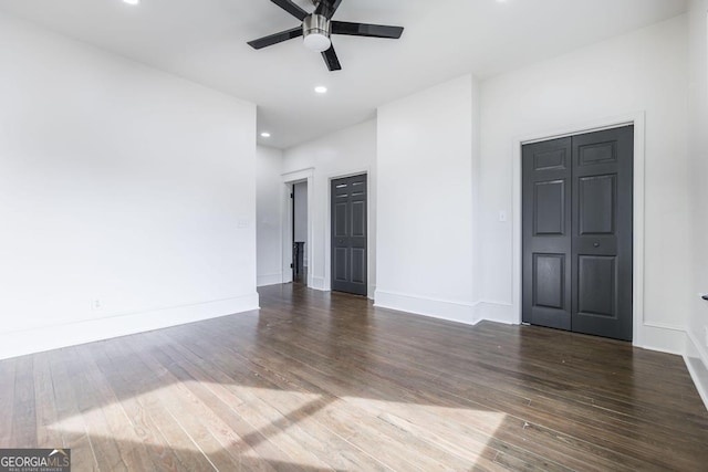 spare room with ceiling fan and dark wood-type flooring