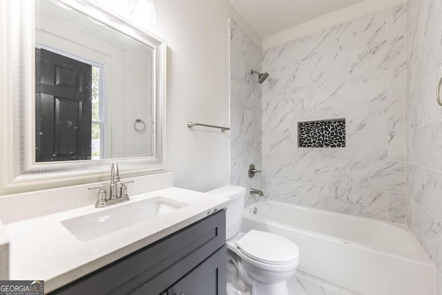 full bathroom with toilet, vanity, and tiled shower / bath