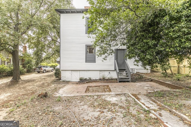 back of property featuring a patio area