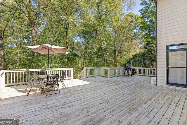 wooden deck with a grill