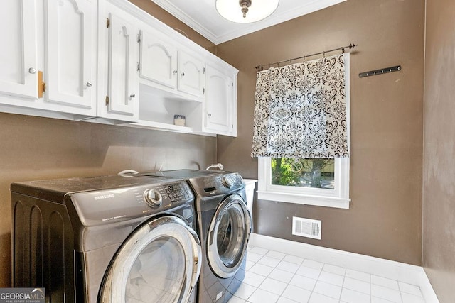 washroom featuring ornamental molding, cabinets, separate washer and dryer, and light tile patterned floors