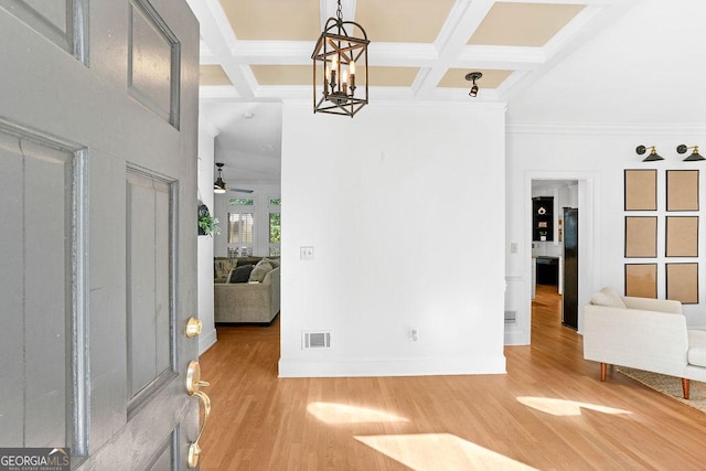 entrance foyer featuring ceiling fan with notable chandelier, coffered ceiling, and beamed ceiling