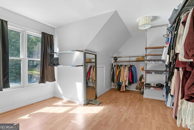 spacious closet featuring lofted ceiling and light wood-type flooring