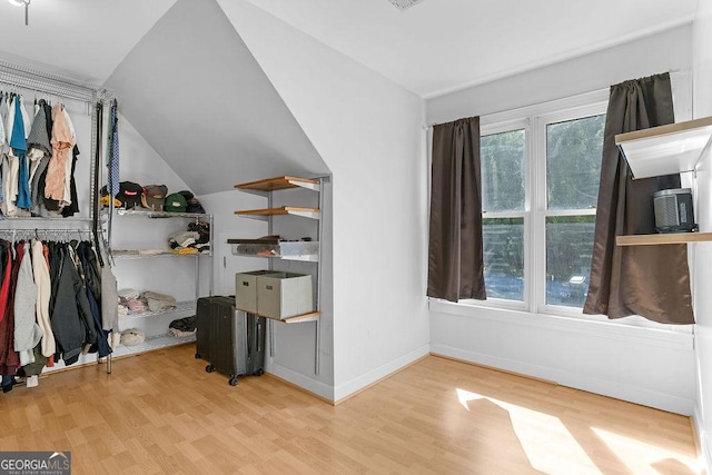 interior space with lofted ceiling and light hardwood / wood-style flooring