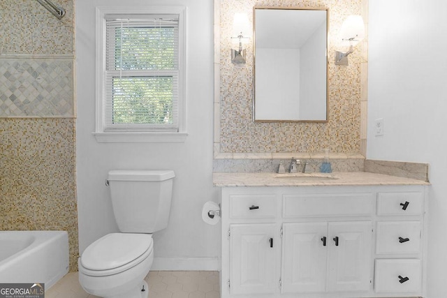 bathroom with toilet, tile patterned floors, and vanity