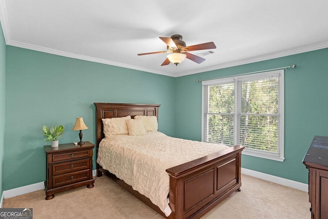 carpeted bedroom featuring ceiling fan and crown molding