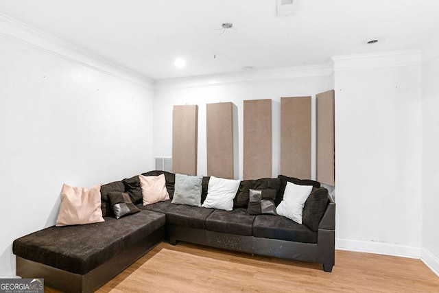 living room with light hardwood / wood-style flooring and crown molding