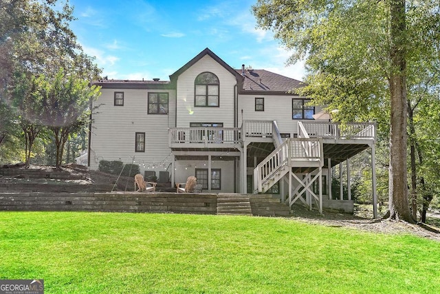 rear view of house featuring a yard and a deck