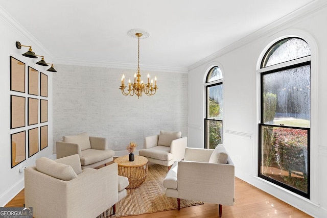 living room featuring ornamental molding, a notable chandelier, and wood-type flooring