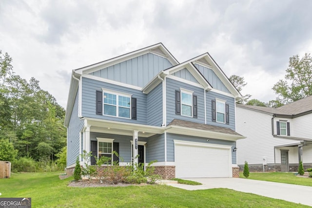 craftsman inspired home with a porch, a front yard, and a garage