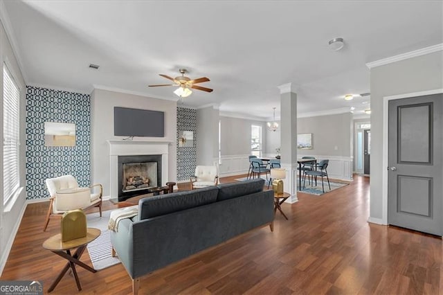 living room featuring ceiling fan, dark hardwood / wood-style floors, and crown molding