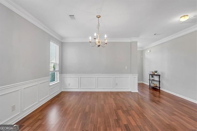 unfurnished room with dark hardwood / wood-style flooring, crown molding, and a notable chandelier