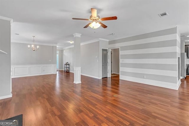 unfurnished living room featuring dark wood-type flooring, ceiling fan with notable chandelier, and ornamental molding