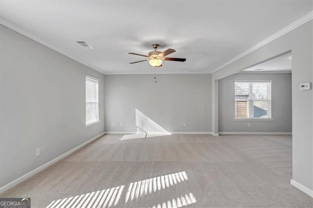 carpeted empty room with ceiling fan and ornamental molding