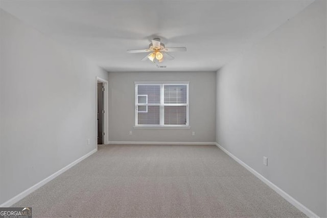 carpeted empty room with ceiling fan