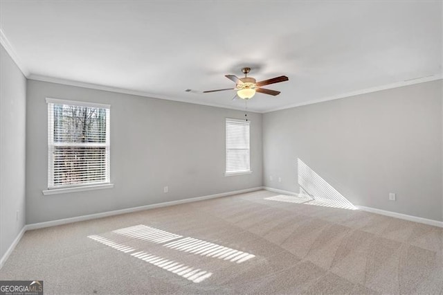 spare room featuring light carpet, ceiling fan, and crown molding