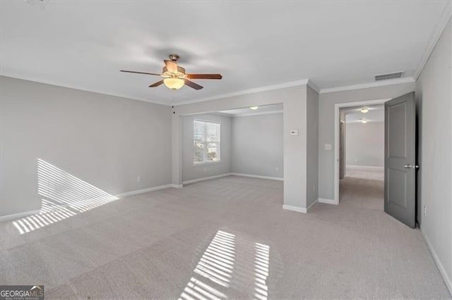 unfurnished bedroom with ceiling fan, light carpet, and crown molding