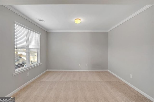 carpeted spare room featuring crown molding