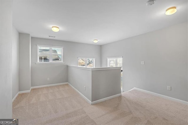 spare room with light colored carpet