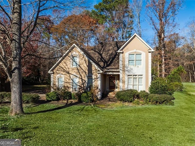 view of property featuring a front lawn