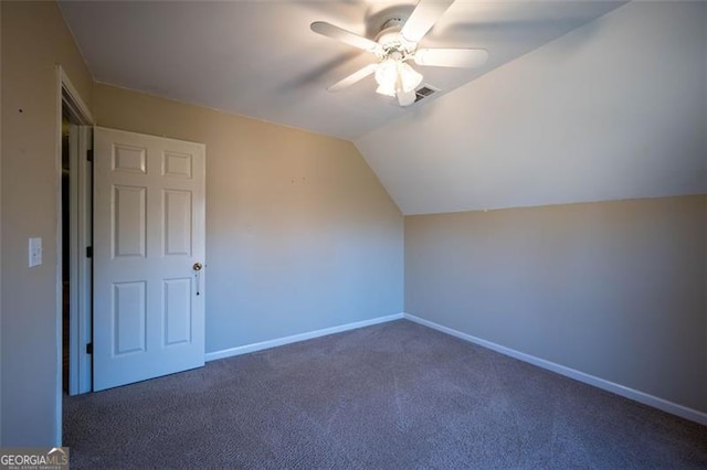 bonus room with dark carpet, ceiling fan, and vaulted ceiling