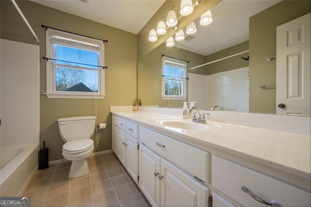 bathroom featuring toilet, tile patterned flooring, and vanity