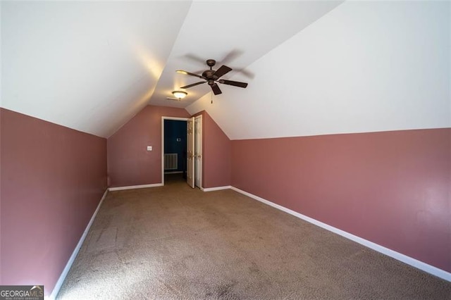 additional living space with lofted ceiling, ceiling fan, and carpet