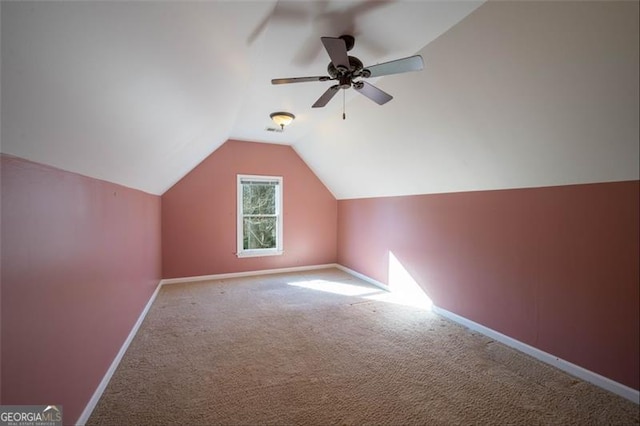 additional living space with lofted ceiling, ceiling fan, and carpet flooring