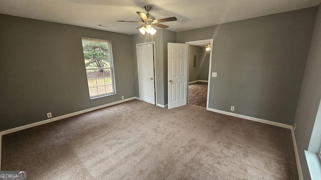 unfurnished bedroom featuring ceiling fan and carpet flooring