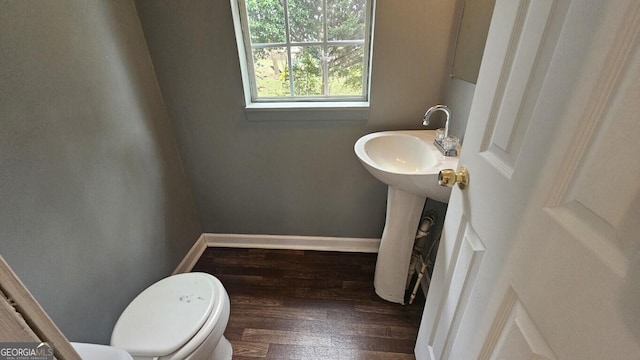 bathroom featuring hardwood / wood-style floors and toilet