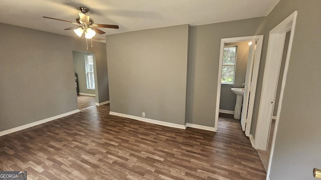 empty room featuring ceiling fan and dark hardwood / wood-style flooring