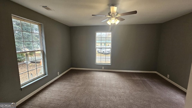 empty room with ceiling fan and carpet floors