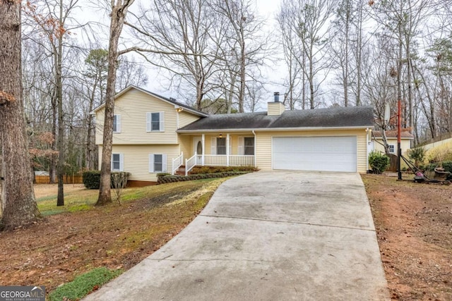 split level home with a garage and covered porch