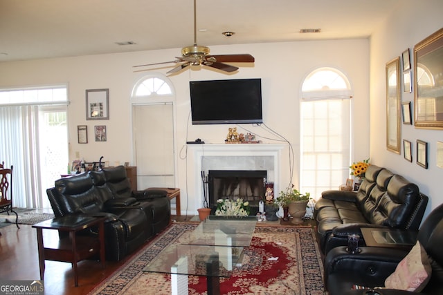 living room with ceiling fan, a fireplace, and hardwood / wood-style floors