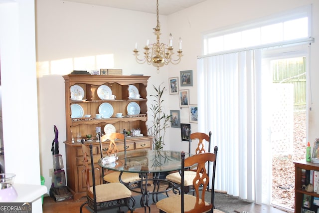 dining space with a wealth of natural light and a notable chandelier