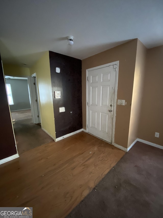 entrance foyer with dark colored carpet