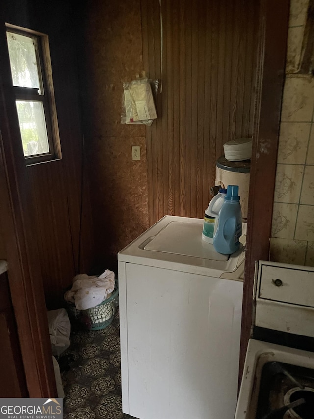 laundry room with washer / dryer and wood walls