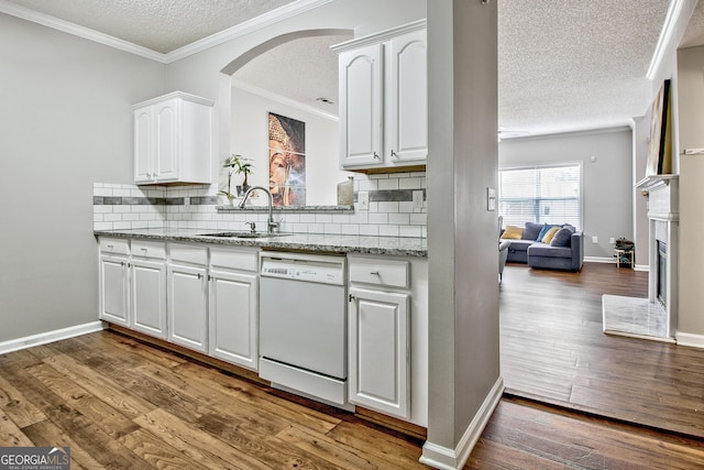 kitchen featuring sink, white cabinets, decorative backsplash, and dishwasher