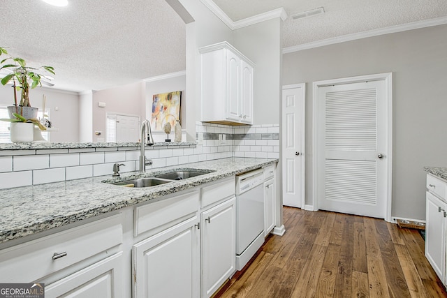 kitchen featuring a textured ceiling, dark hardwood / wood-style floors, white dishwasher, white cabinets, and sink