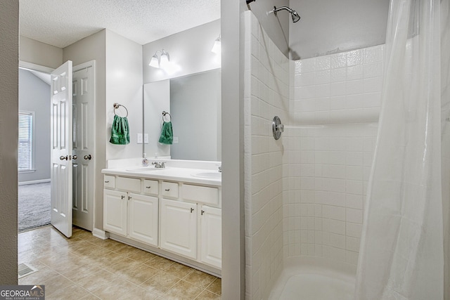 bathroom with vanity and a textured ceiling