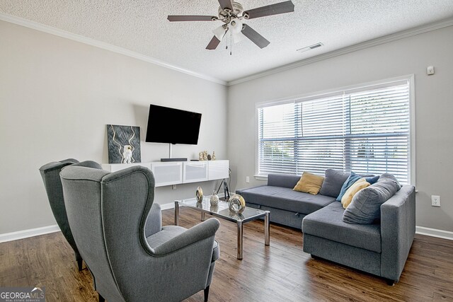 living room with a textured ceiling, ceiling fan, crown molding, and dark hardwood / wood-style floors