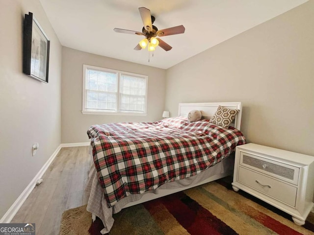 bedroom with ceiling fan and hardwood / wood-style floors