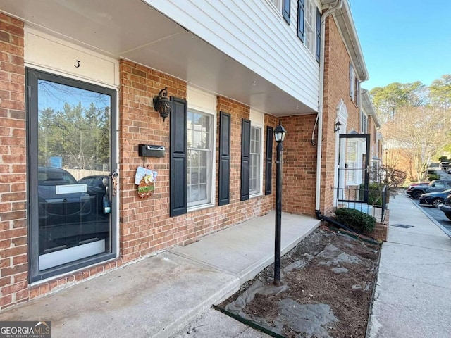 view of exterior entry featuring a porch