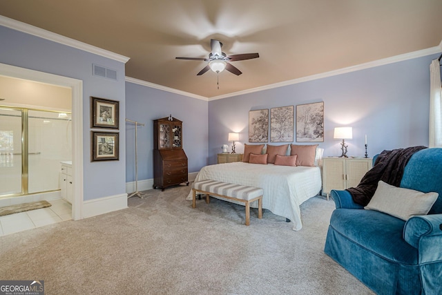 carpeted bedroom with ensuite bathroom, visible vents, baseboards, tile patterned floors, and crown molding